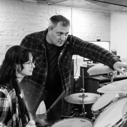 Sol Garnier teaching drum lesson with adult student